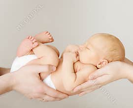 Baby newborn sleeping on parents family hands