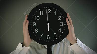Businessman with clock in front of his head
