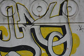 A bright,The graffiti depicting the word in Russian KASHAU, ????? is painted on a white and gray concrete fence.