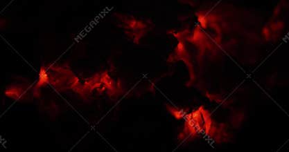 Close-up view of glowing embers and ashes creating a warm, fiery atmosphere that evokes coziness and