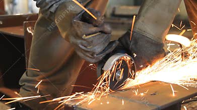 Industrial Worker cutting steel metal.
