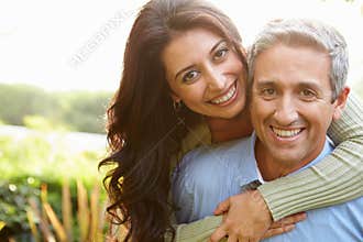 Portrait Of Loving Hispanic Couple In Countryside