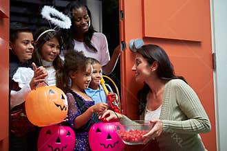 Children Going Trick Or Treating With Mother