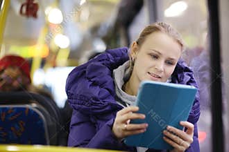 Woman with touchpad in the bus