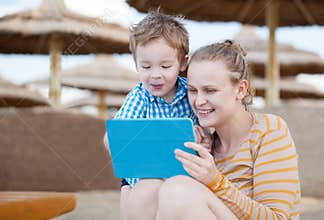 Happy mother and son at a beach resort