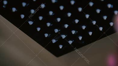 The tropical shower head is treated with a cleaning spray.