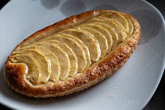 French fresh baked sweet puff pastry with fresh apple fruits in sirup in confectionery shop