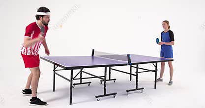 Playing table tennis, man and woman competing in intense match indoors