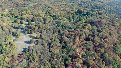 Flying over the hills with autumn forest