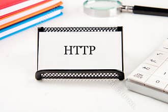 Document holder showing HTTP label placed next to a calculator and books on a desk