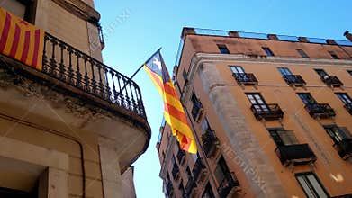 Girona, Spain, October 3, 2024: Catalan Independence Flag on Historical Building in Urban Landscape
