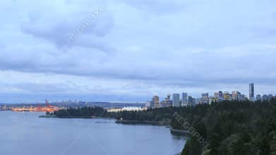Vancouver BC Canada City Skyline with Moving Clouds and Traffic along Stanley Park Seawall at Blue Hour