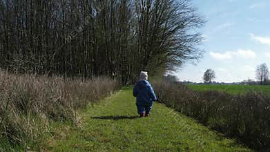 Child walking along pathway