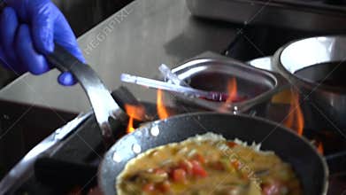 Chef Pouring Beaten Eggs Over Sauteed Vegetables in Hot Pan – Slow Motion