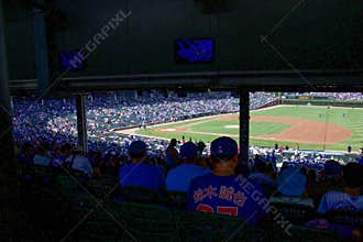 Exciting Baseball Game in a Packed Stadium During the Afternoon in Chicago