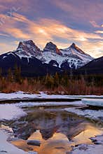 Winter sunset at The Three Sisters, a trio of peaks near Canmore, Alberta, Canada