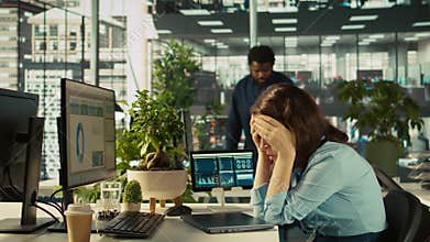 Accountant in busy modern startup agency imputing financial figures on PC