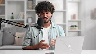 Microphone, podcast and Indian man speaker in his living room. Creative streamer, internet influencer or online content