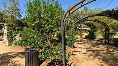 footage of a water fountain with lush green trees and plants and colorful flowers at Descanso Gardens