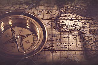 Old nautical compass over the map