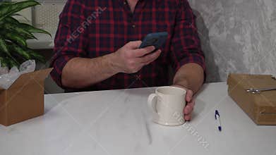 The guy takes a picture of the defect on the cup to register the return of the