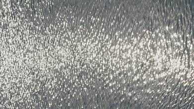 The view of swimming pool water surface at sunset, sun reflection