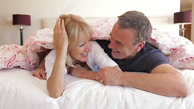 Senior husband and wife snuggled