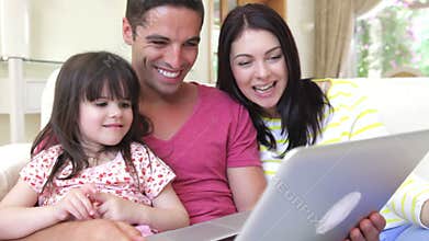 Family relaxing on sofa together