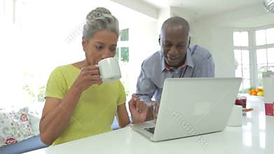 Mature African American Couple Using Laptop At Home