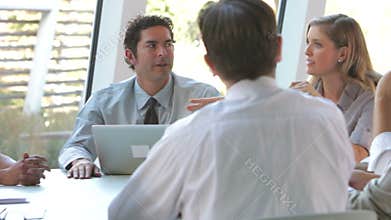 Group Of Businesspeople With Laptop Having Meeting