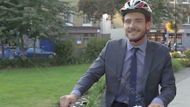 Businessman Riding Bike Through City Park