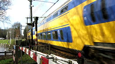 Doubledeck train passing by crossing