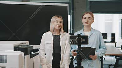 Business professionals discuss project details in modern office environment while filming presentation