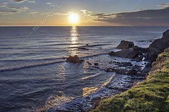 High tide at sunset time Sandymouth Bay