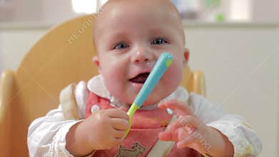 Happy Young Baby Boy In High Chair