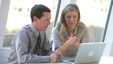 Two Business People With Laptop Having Meeting