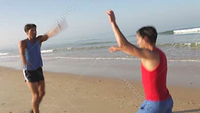 Two Men Working Out On Beach Together