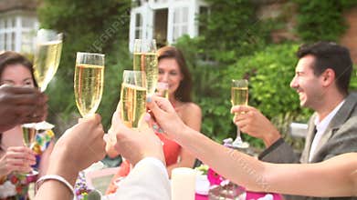 Slow Motion Sequence Of Friends Proposing Champagne Toast