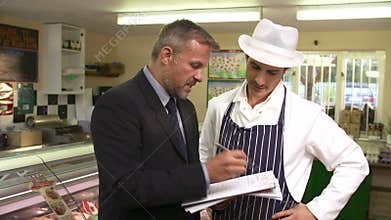 Bank Manager Meeting With Owner Of Butchers Shop