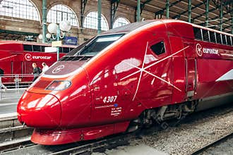 Modern red Eurostar high-speed train at Gare du Nord railway station