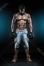 Muscular bodybuilder guy doing exercises with dumbbells over black background