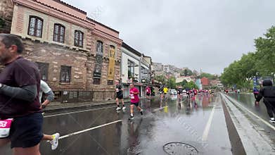 Athletes running Istanbul half marathon in historic street of Fener district