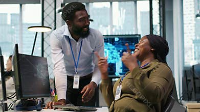 Cheerful programmers in office enjoying conversation while automating with AI