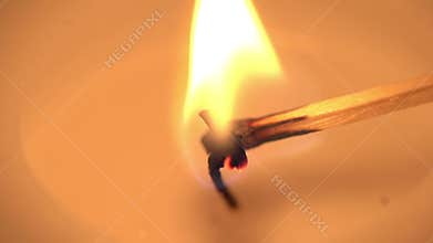 A candle is lit in slow motion