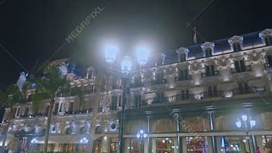 Monaco, Monte Carlo, 05 March 2025: View of the facade of the famous Paris Hotel with illumination on the famous Place