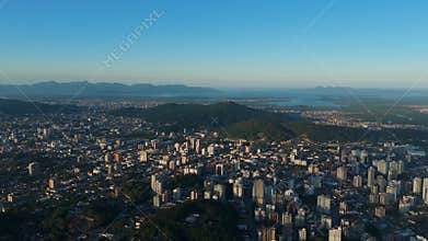 Panoramic Drone View of a Mid-Sized Brazilian City with Buildings and Green Areas Under a Clear Sky