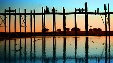 People on the old teak bridge. Burma, Mandalay, sunset