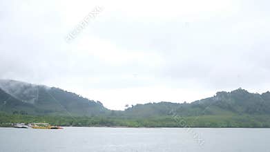 Misty Mountains Over Coastal Waters