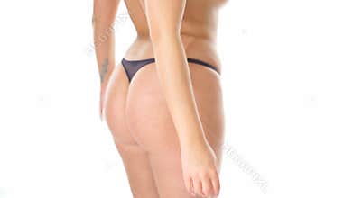 Closeup of woman's behind in strings panties