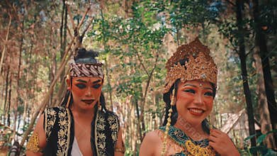 Traditional Javanese Couple Looking Around in a Forest